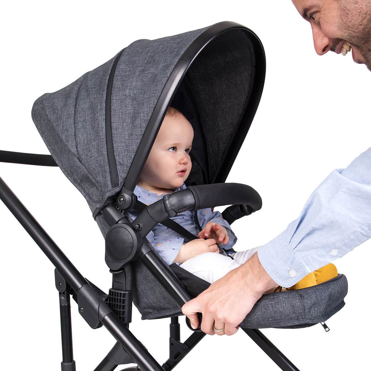 phil&teds voyager in charcoal grey with baby staying confortable with footrest 3 qtr view_charcoal